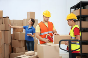 workers packing boxes at warehouse