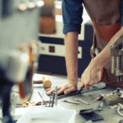 craft workshop owner at his work place