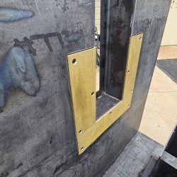 Hydraulic Tilter/Upender for Materials Processing Manufacturer, Close Up of Bronze Plate