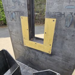 Hydraulic Tilter/Upender for Materials Processing Manufacturer, Close Up of Bronze Plate